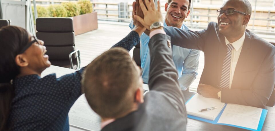 Exultant team of business professionals Performance Coaching?